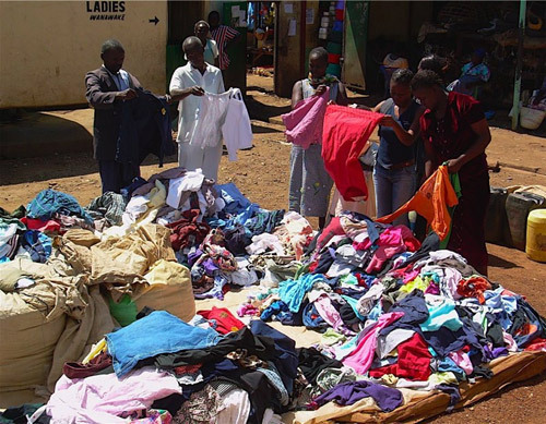 People looking at second-hand clothes at a mitumba market in Kenya